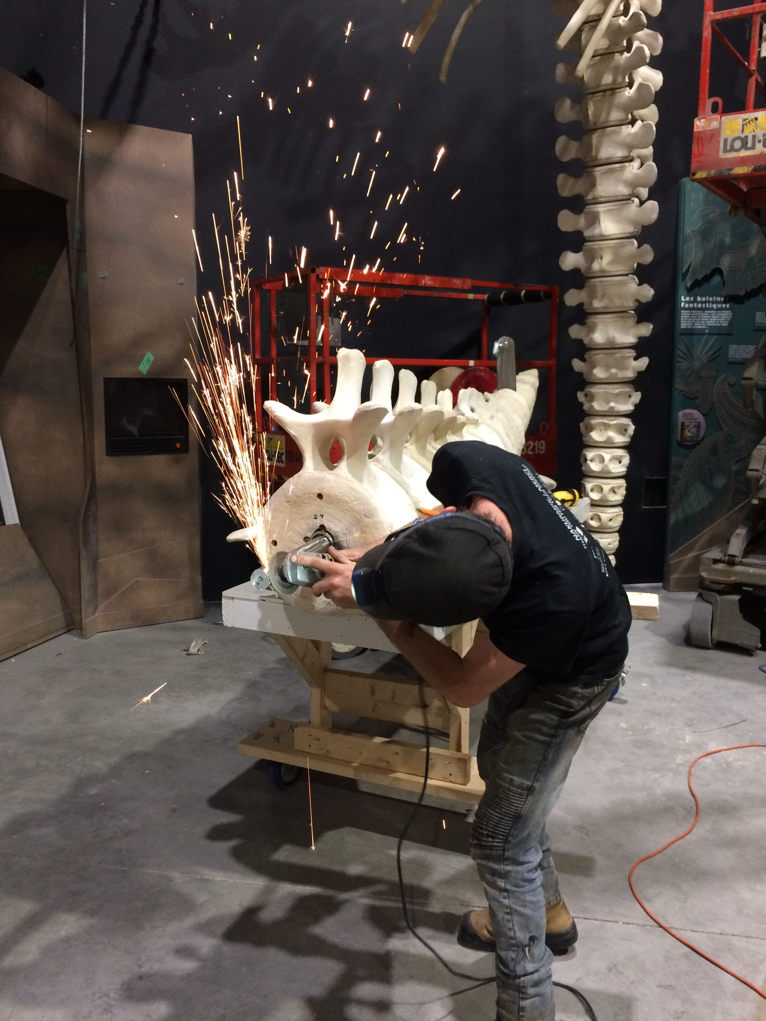 A technician welds a metal structure that will allow the whale to be positioned dynamically in the exhibition
