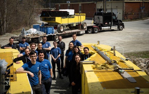 The Oneka Technologies team in front of a truck transporting a desalination buoy
