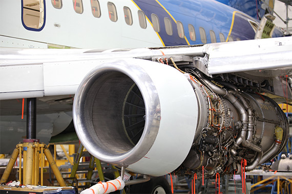 An airplane engine on an aircraft being built.